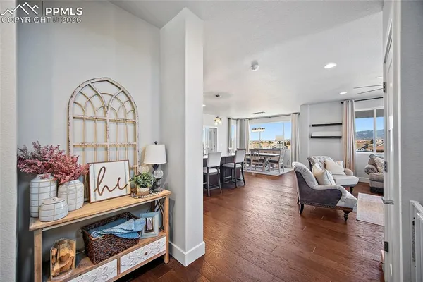 a view of a hallway to a livingroom with furniture and staircase