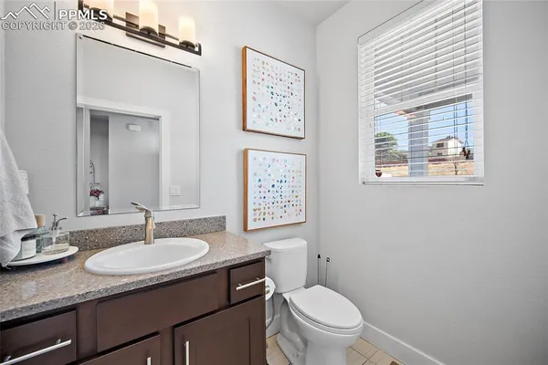 a kitchen with a sink stove cabinets and wooden floor