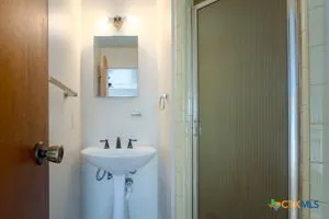 a bathroom with a sink and mirror