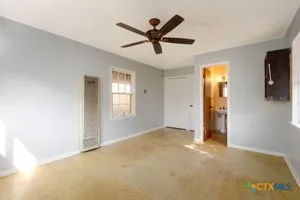 a view of a livingroom with a ceiling fan and window