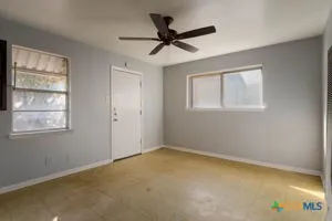 a view of room with window and ceiling fan