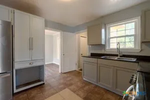 a kitchen with stainless steel appliances granite countertop a sink and cabinets