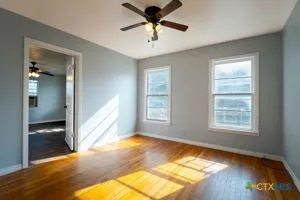 a view of a livingroom with a window and a ceiling fan