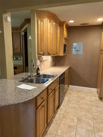 a kitchen with a sink a counter top space and cabinets