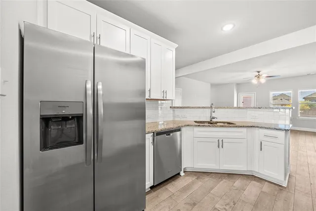 a kitchen with a sink stainless steel appliances and cabinets