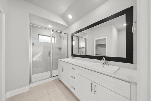 a bathroom with a double vanity sink mirror double and shower