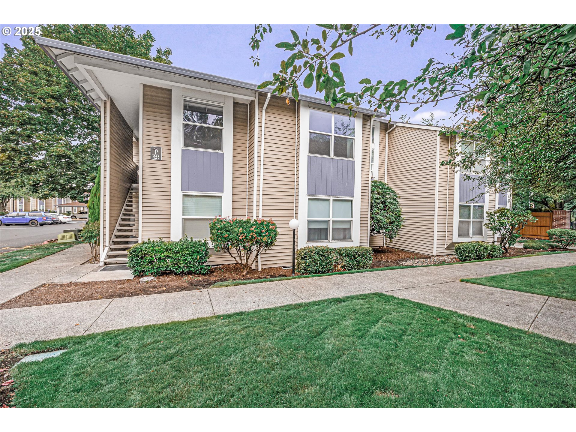 4686 West Powell Boulevard, Unit 241 Gresham, OR 97030 - Photo 1 of 44 a front view of a house with a garden and yard
