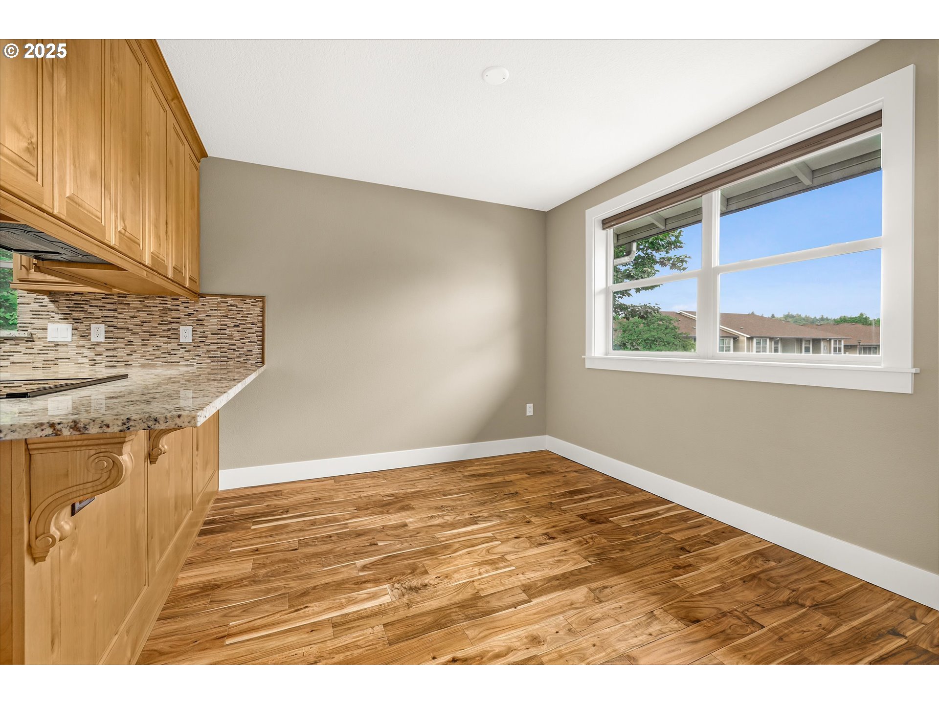 4686 West Powell Boulevard, Unit 241 Gresham, OR 97030 - Photo 13 of 44 a view of an empty room with wooden floor and a window