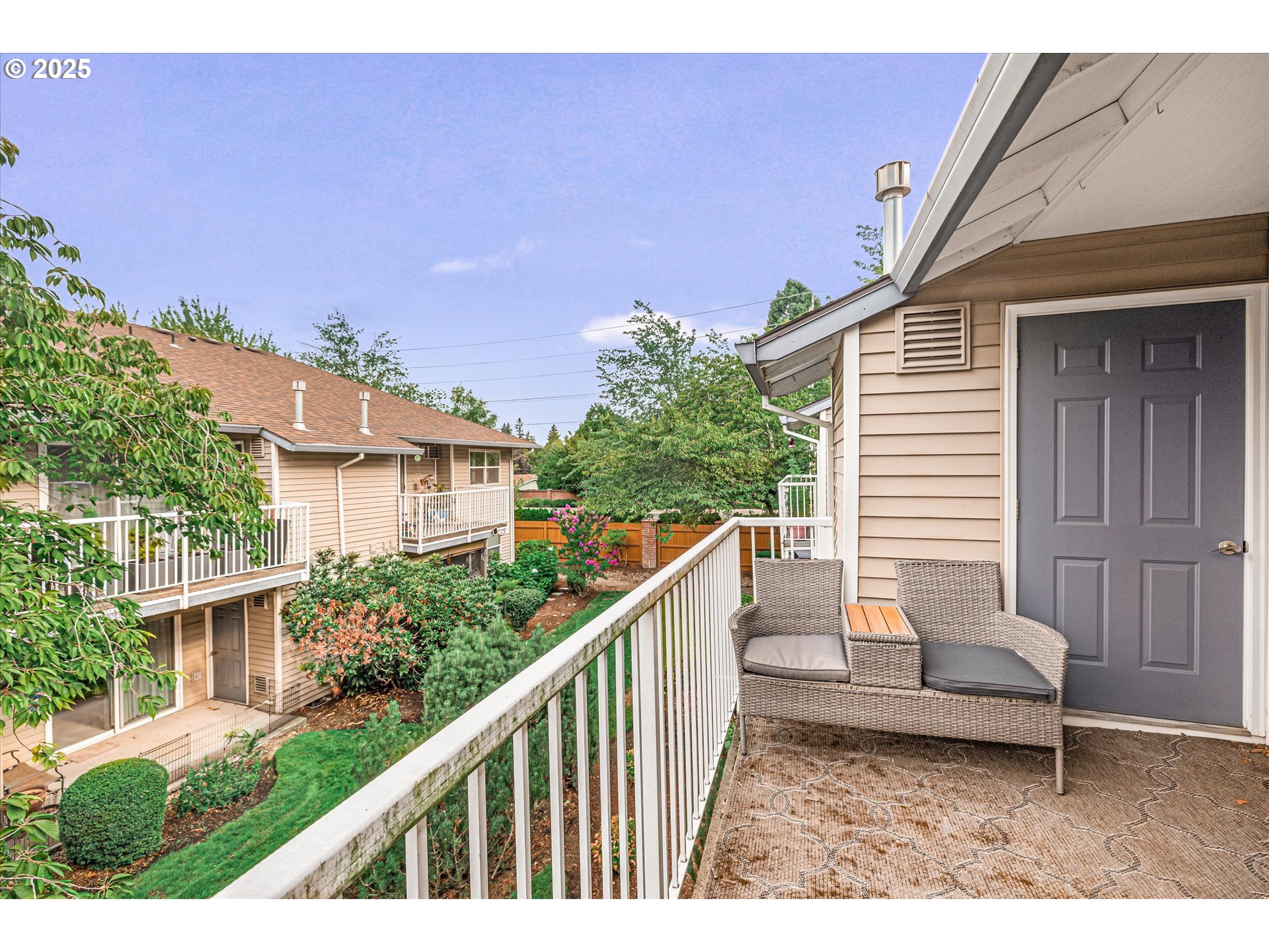4686 West Powell Boulevard, Unit 241 Gresham, OR 97030 - Photo 19 of 44 a balcony with wooden floor and outdoor seating