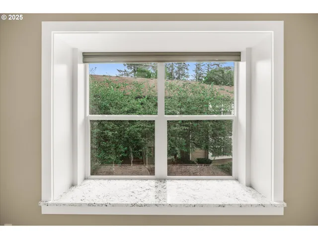 a bathroom with a granite countertop sink a mirror and a toilet