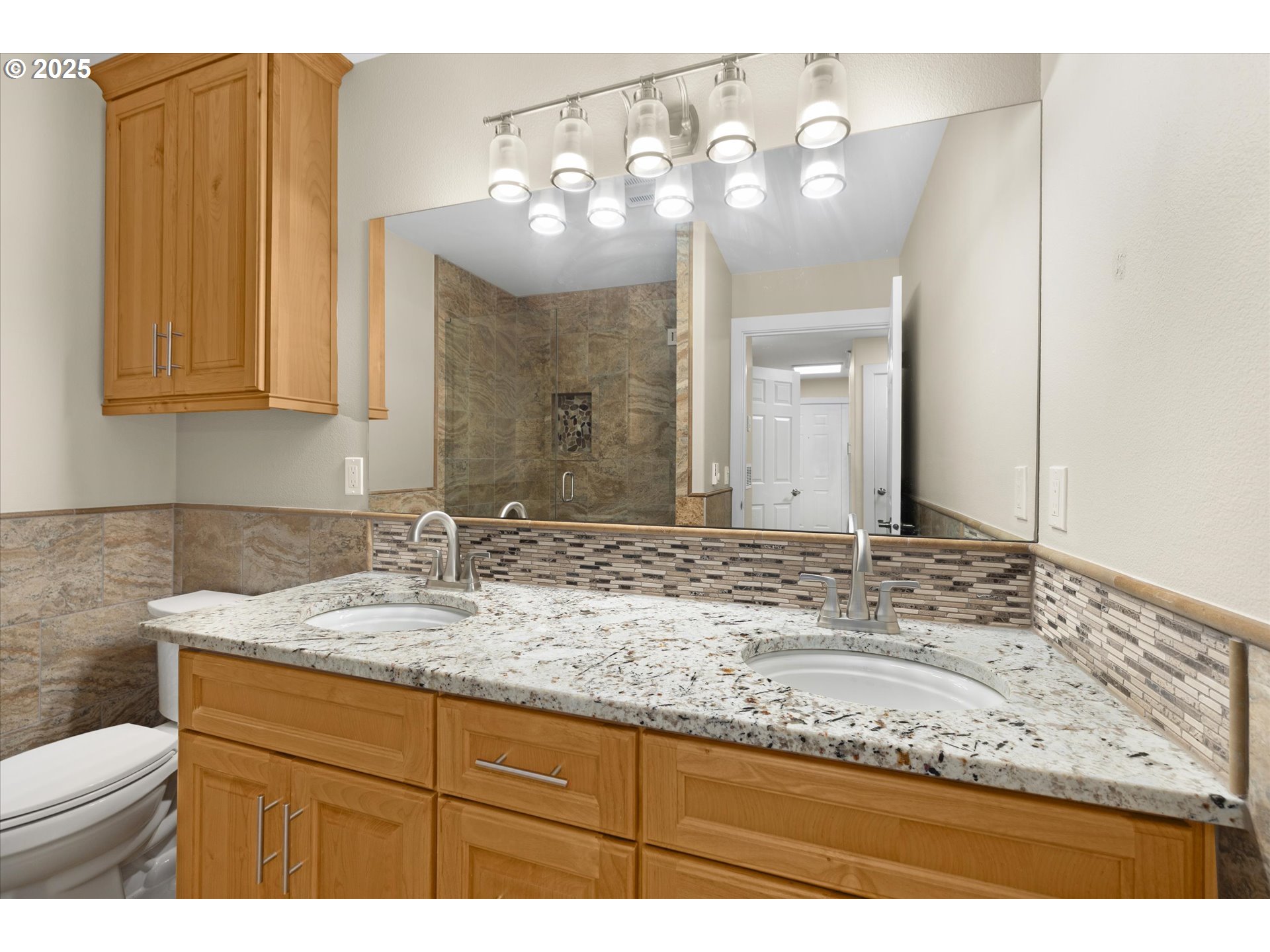 4686 West Powell Boulevard, Unit 241 Gresham, OR 97030 - Photo 26 of 44 a bathroom with a granite countertop sink a mirror and a toilet
