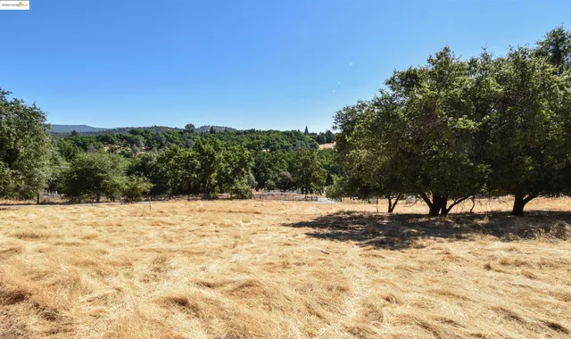 a view of a yard covered with snow in front of house