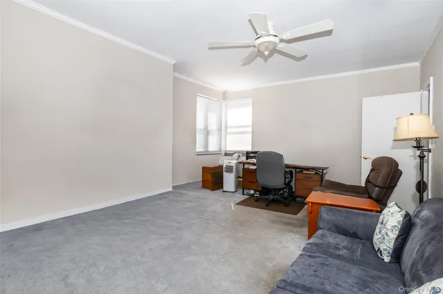 a living room with furniture and a lamp