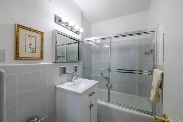 a bathroom with a shower sink and mirror