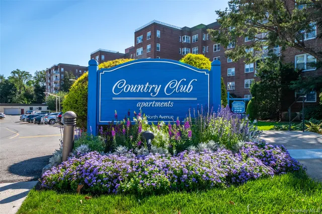 a sign that is sitting in front of flowers