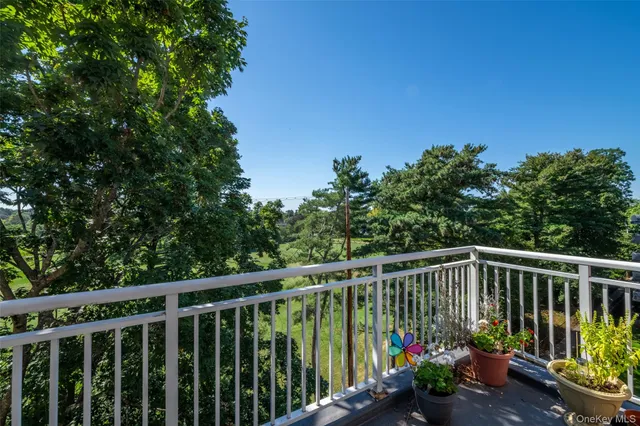 a view of a balcony with flower plants