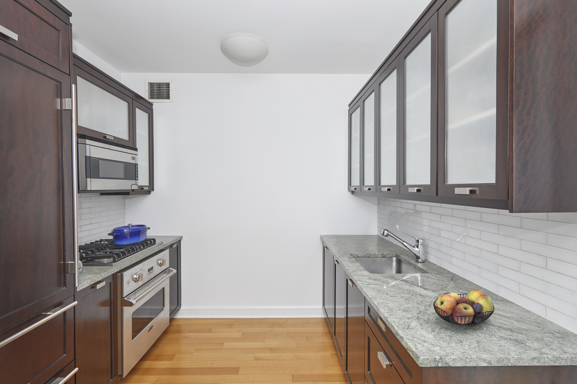 80 Riverside Boulevard, Unit 19B Manhattan, NY 10069 - Photo 6 of 18 a kitchen with stainless steel appliances granite countertop a sink and cabinets