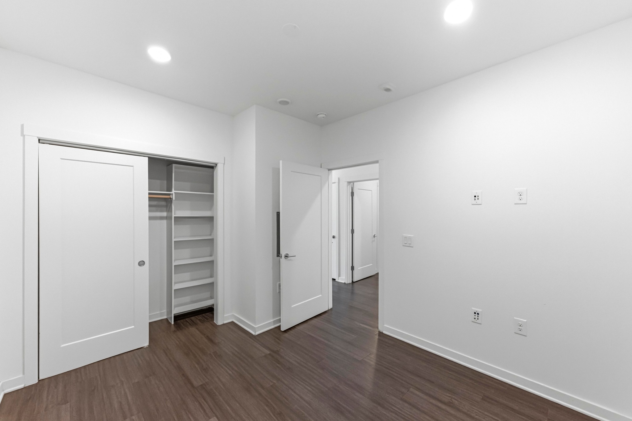 4361 South Congress Avenue, Unit 309 Austin, TX 78745 - Photo 14 of 37 Unfurnished bedroom featuring dark wood finished floors, a closet, and recessed lighting