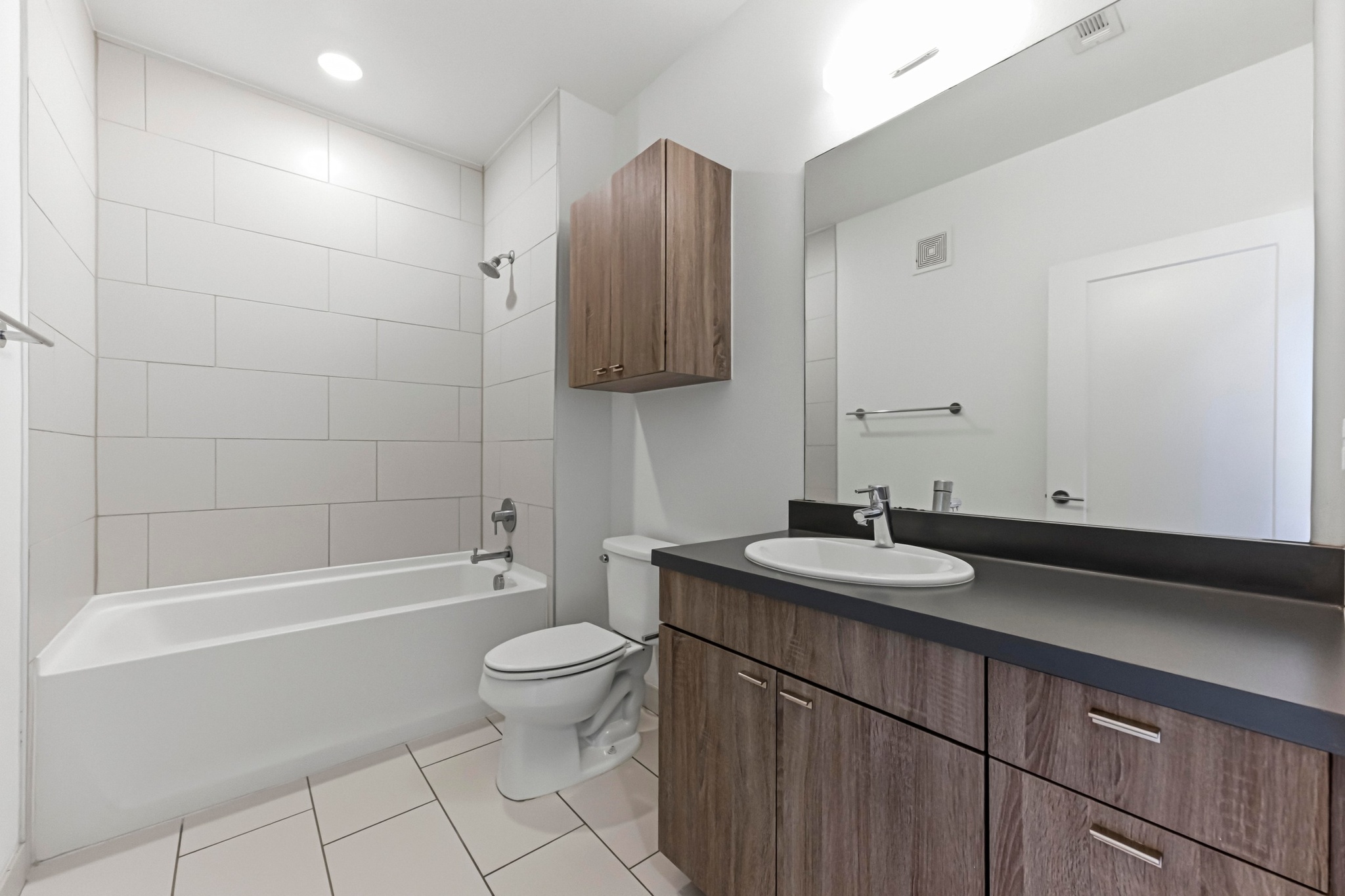 4361 South Congress Avenue, Unit 309 Austin, TX 78745 - Photo 18 of 37 Bathroom featuring vanity, bathing tub / shower combination, light tile patterned flooring, and recessed lighting