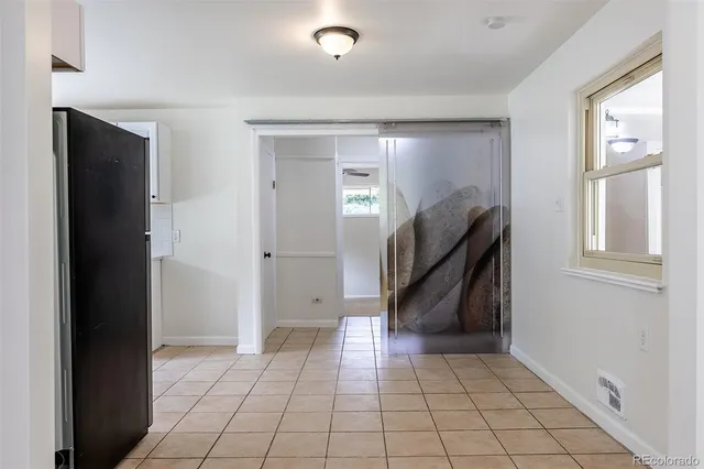 a kitchen with a refrigerator and a stove