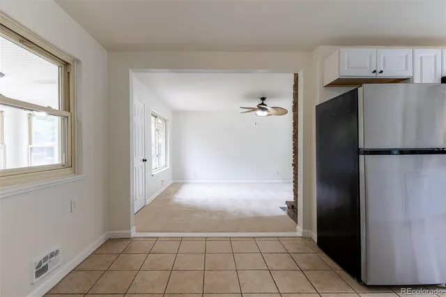 a kitchen with a refrigerator a sink and cabinets