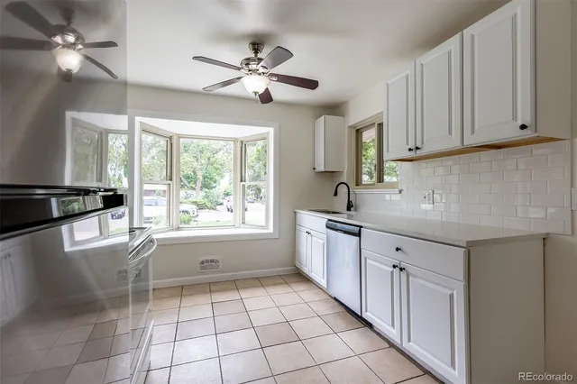 a kitchen with a sink cabinets and window
