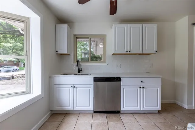 a kitchen with a stove top oven and refrigerator