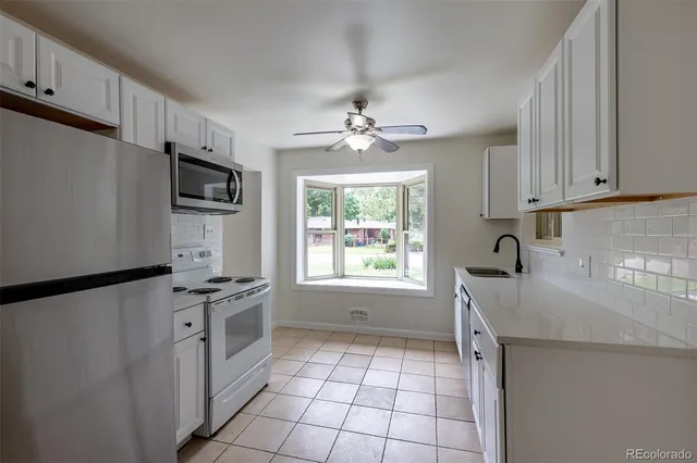 a view of an empty room with a fireplace and a window