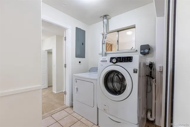 a view of a kitchen with white cabinets