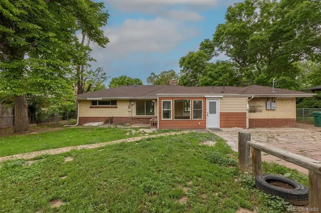 a view of a yard in front of a house with large trees