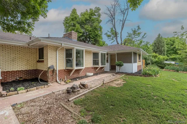 a view of a house with backyard sitting area and garden