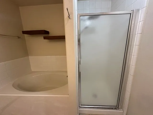 a bathroom with a glass shower door