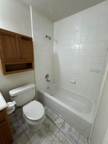 a bathroom with a toilet a sink and bathtub