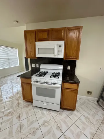 a kitchen with stainless steel appliances a stove a sink and a cabinets