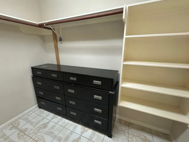 a bathroom with a sink vanity and tub