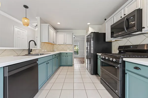 a kitchen with stainless steel appliances granite countertop a sink a stove a microwave and cabinets