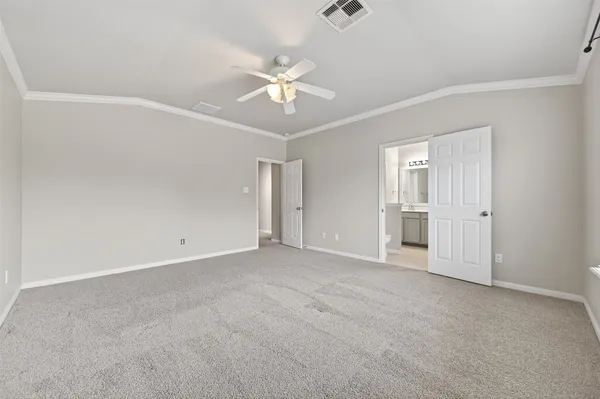 an empty room with closet and windows