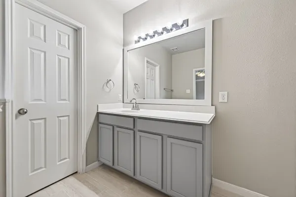 a bathroom with a double vanity sink and a mirror