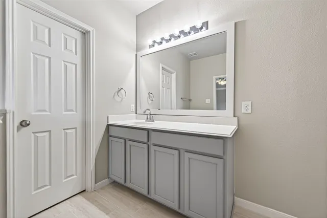 a bathroom with a double vanity sink and a mirror