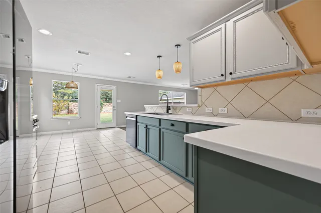 a kitchen with a sink cabinets and window
