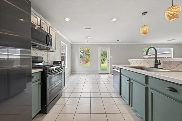 a kitchen with stainless steel appliances granite countertop a sink and a stove