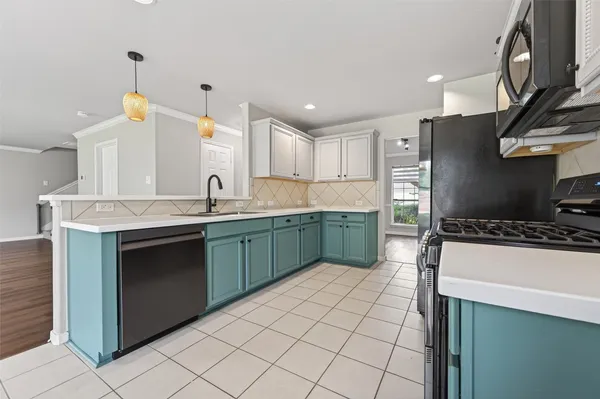 a kitchen with a sink appliances and cabinets