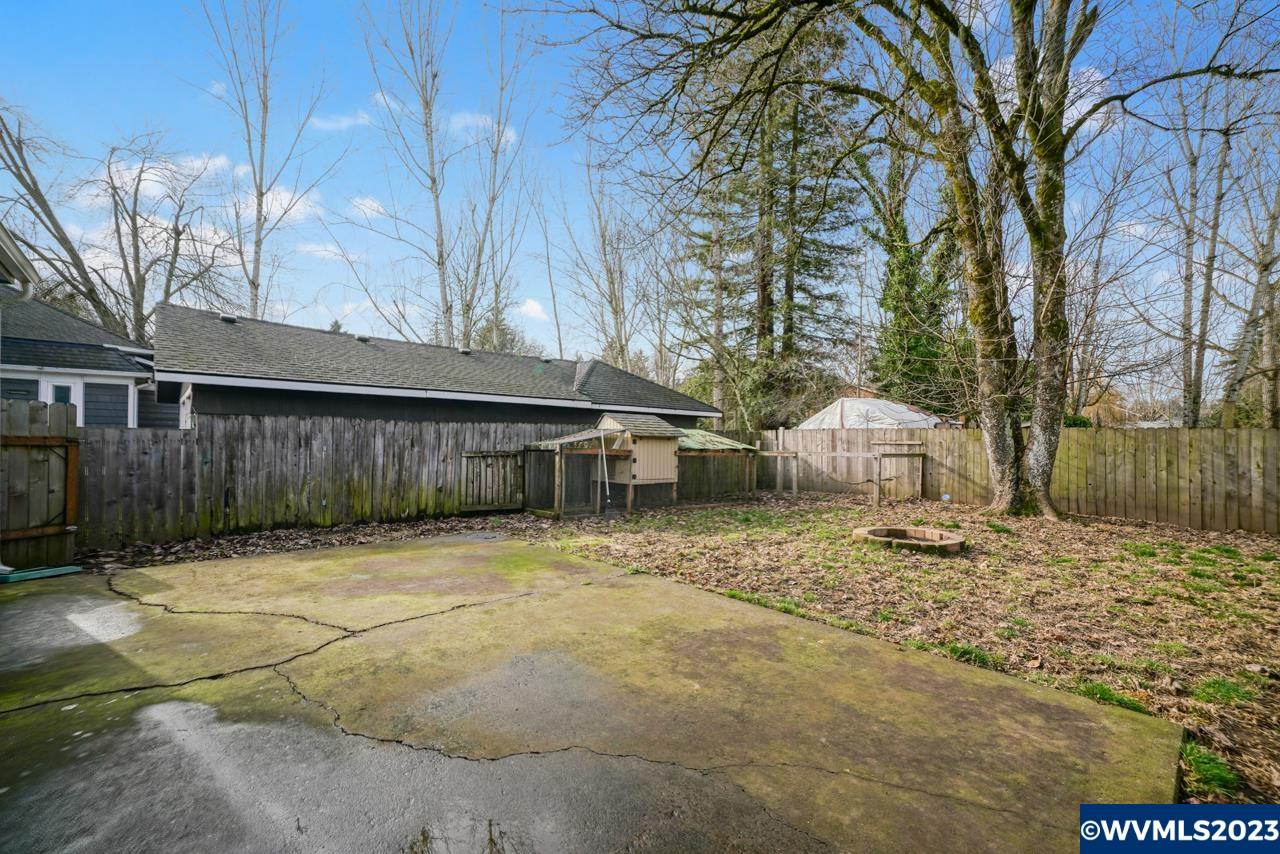 3039 Pringle Road Southeast Salem, OR 97302 - Photo 27 of 29 a backyard of a house with large trees and wooden fence