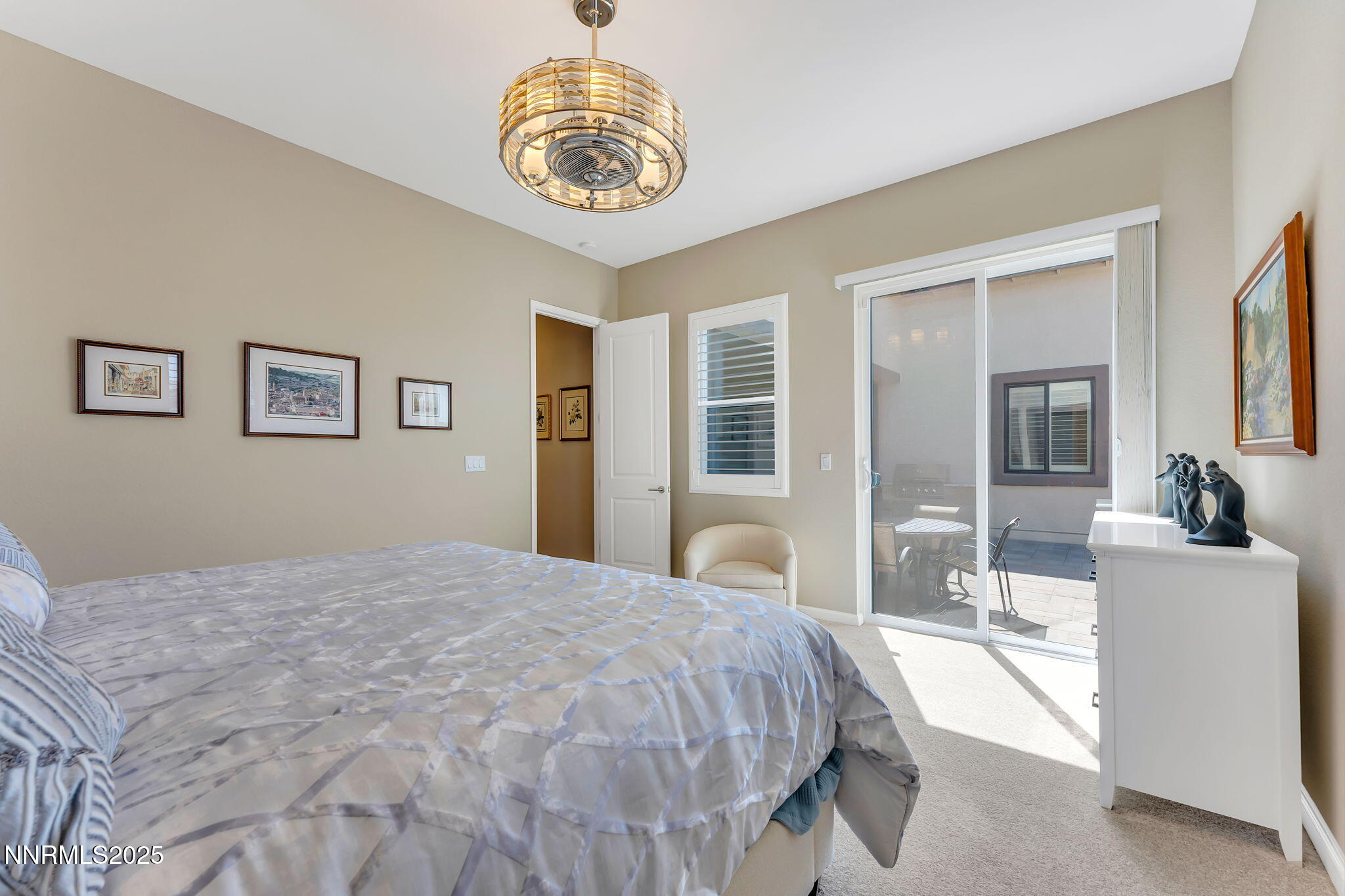 2121 Kate's Bridge Drive Reno, NV 89521 - Photo 18 of 35 a bedroom with a large bed and a chandelier