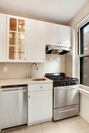 a kitchen with granite countertop white cabinets and white appliances