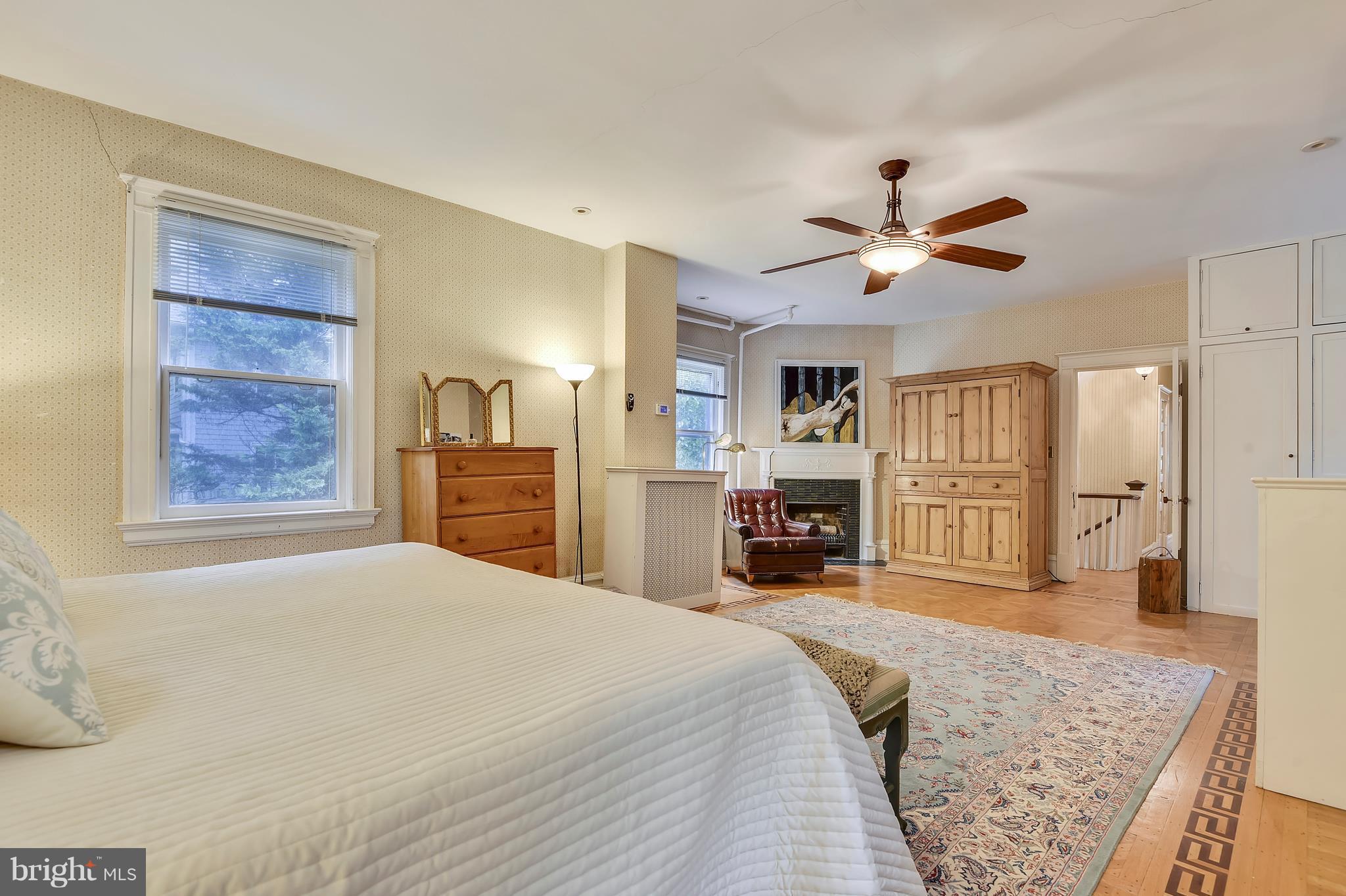 501 Hawthorn Road Baltimore, MD 21210 - Photo 13 of 30 a bedroom with a large bed a flat tv screen and a chandelier