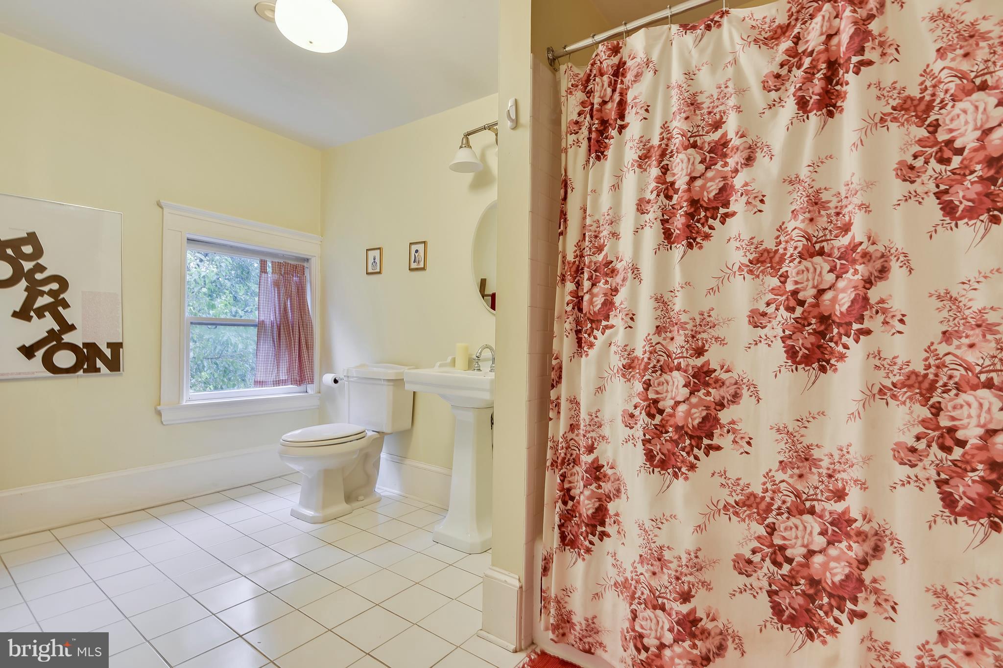 501 Hawthorn Road Baltimore, MD 21210 - Photo 23 of 30 a bathroom with a toilet and a shower curtain