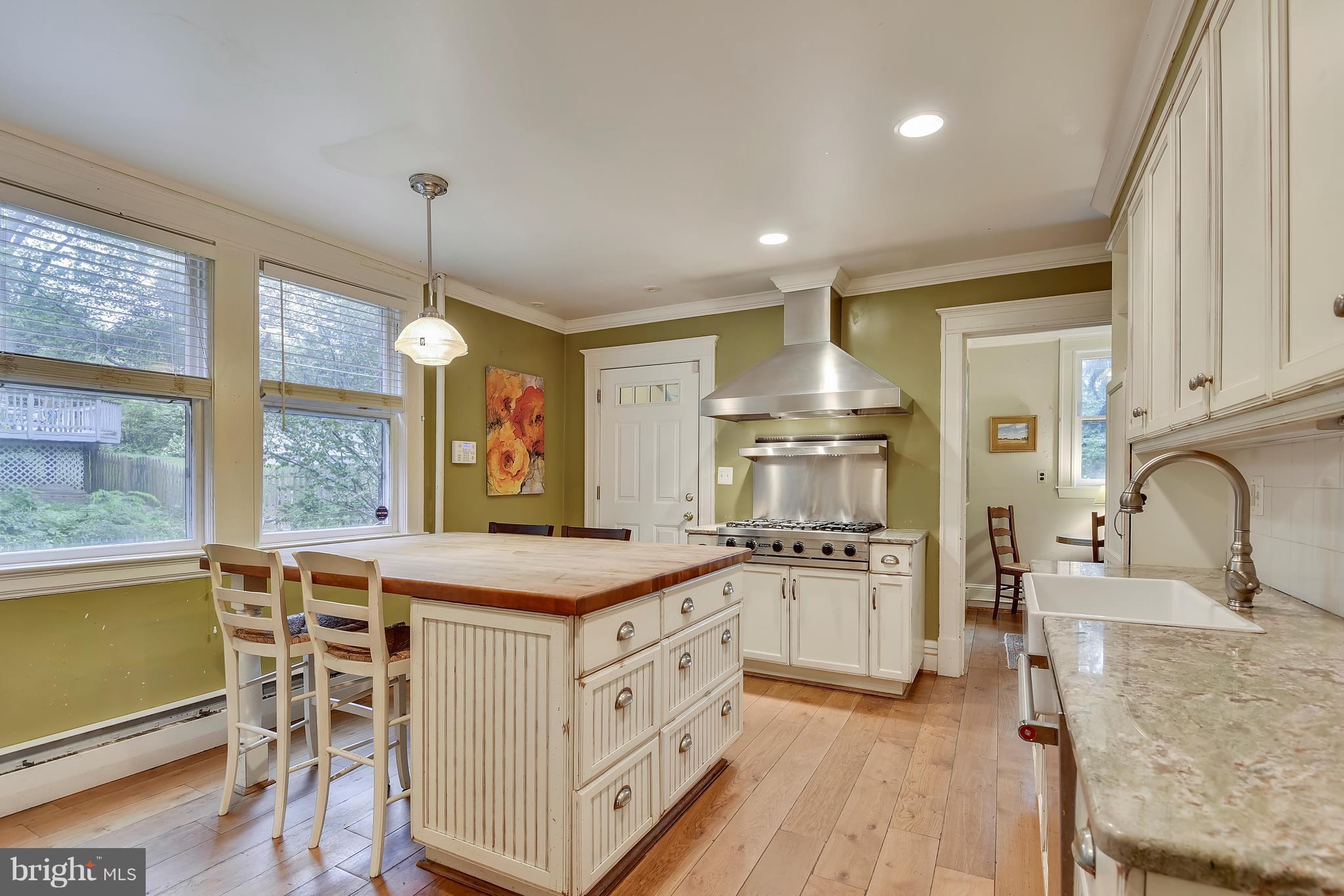 501 Hawthorn Road Baltimore, MD 21210 - Photo 4 of 30 a kitchen with white cabinets and wooden floor