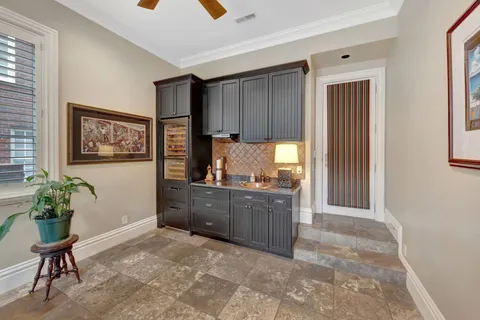 a living room with furniture and large windows