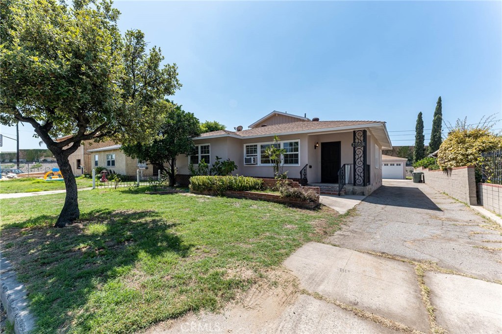 a view of a house with backyard porch and sitting area